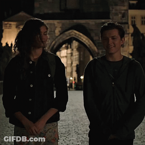Man And Woman On Cobblestone Street GIF