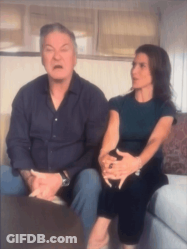 Man And Woman On Couch Man Making Funny Face GIF