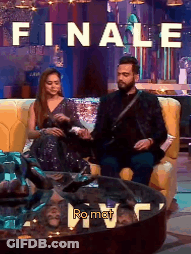 Man And Woman On Couch With Finale Ro Mat Sign GIF