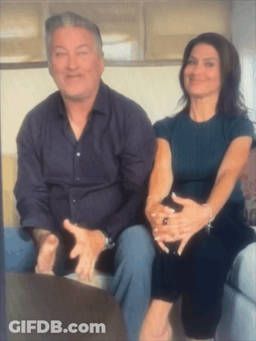 Man And Woman On Couch With Hands On Each Other GIF