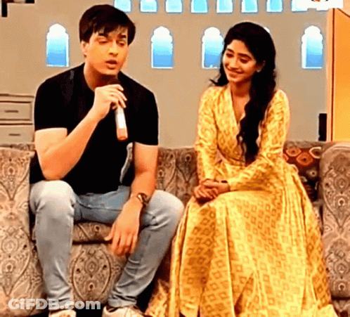 Man And Woman On Couch With Microphone GIF