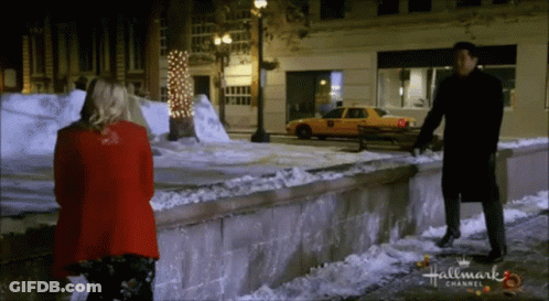 Man And Woman On Snowy Sidewalk GIF