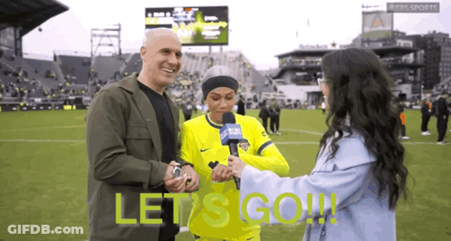 Man And Woman On Soccer Field Saying Let's Go GIF