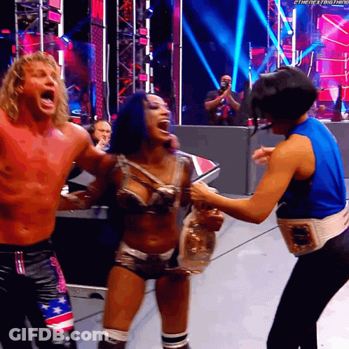 Man And Woman On Stage With Belt Saying The Next Thing GIF