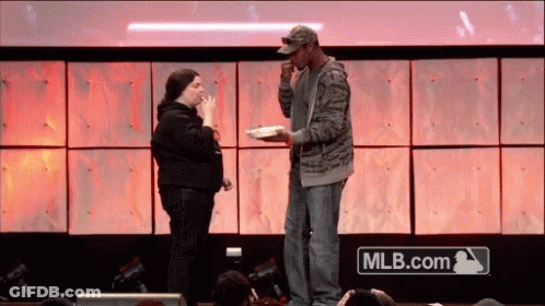 Man And Woman On Stage With MLB.com Logo GIF