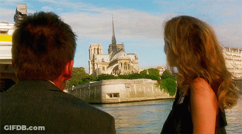 Man And Woman Overlooking Cathedral By Water GIF