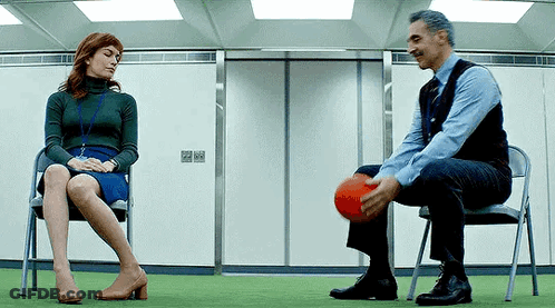 Man And Woman Playing Ball In Chairs GIF