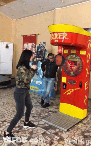 Man And Woman Playing Boxing Machine GIF