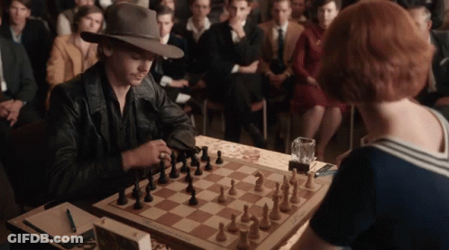 Man And Woman Playing Chess GIF