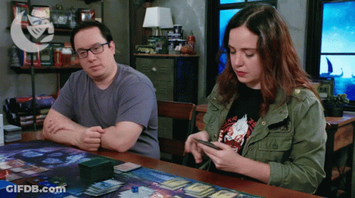 Man And Woman Playing Game At Table GIF