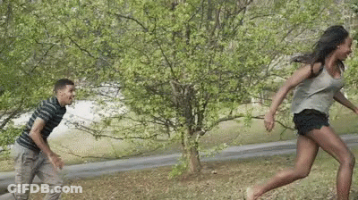Man And Woman Playing Game In Park GIF