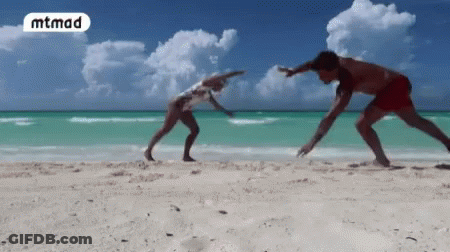 Man And Woman Playing On Beach With Word Mtmad GIF