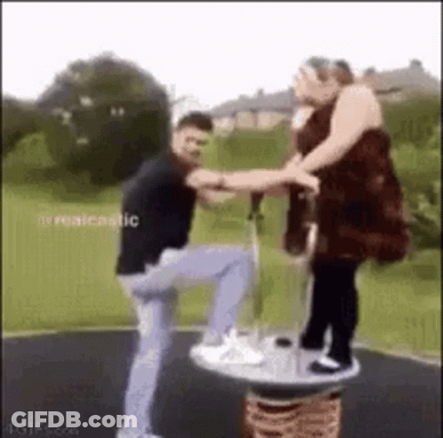 Man And Woman Playing On Merry-Go-Round GIF