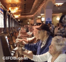 Man And Woman Playing Slot Machine GIF