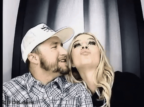 Man And Woman Posing In Booth GIF