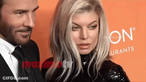 Man And Woman Posing In Front Of Sign GIF