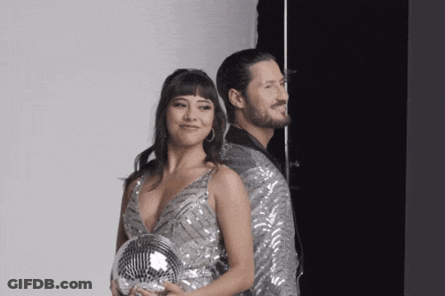 Man And Woman Posing With Disco Ball GIF