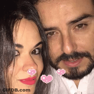 Man And Woman Posing With Pink Hearts On Faces GIF