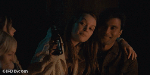 Man And Woman Posing, Woman Holds Jack Daniels GIF