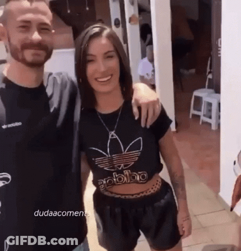 Man And Woman Posing, Woman In Black Adidas Shirt GIF