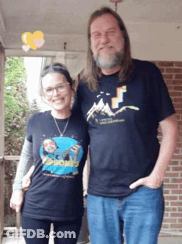 Man And Woman Posing Woman Wearing Rock Phones Shirt GIF