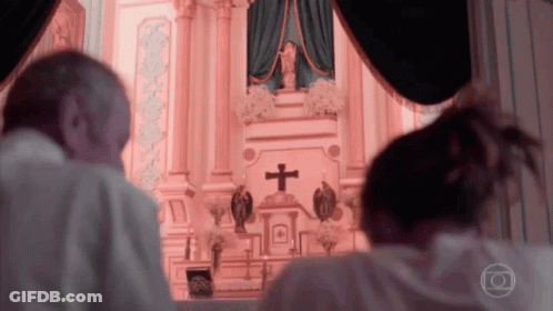 Man And Woman Praying At Altar With Cross GIF