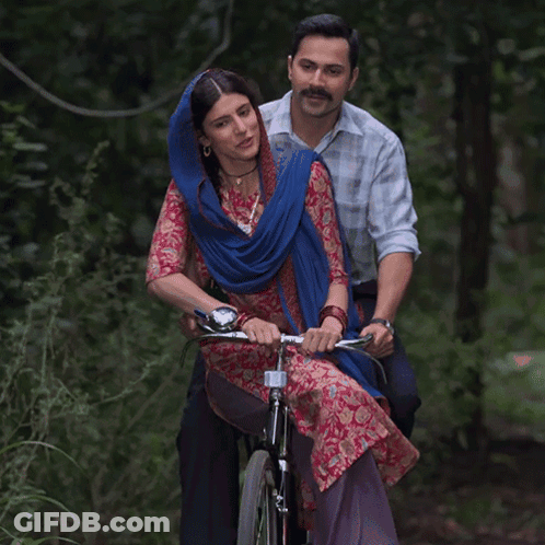 Man And Woman Riding Bicycle In Woods GIF