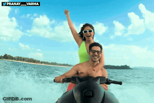 Man And Woman Riding Jet Ski With Pranay Varma Logo GIF