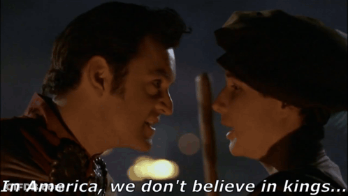 Man And Woman Saying In America We Don't Believe In Kings GIF