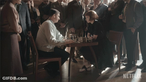 Man And Woman Shaking Hands Before Crowd With Netflix Logo GIF