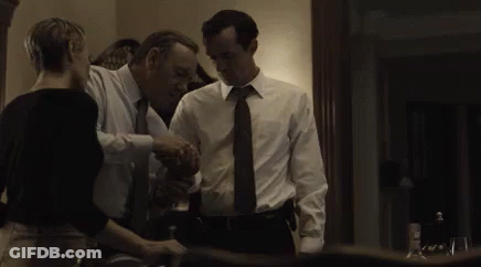 Man And Woman Shaking Hands In Living Room GIF