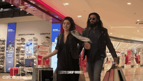 Man And Woman Shopping Weekend Offer GIF