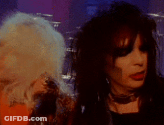 Man And Woman Singing Into Microphone GIF