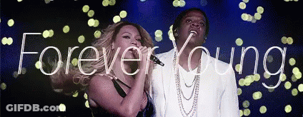 Man And Woman Singing Into Microphones Forever Young GIF