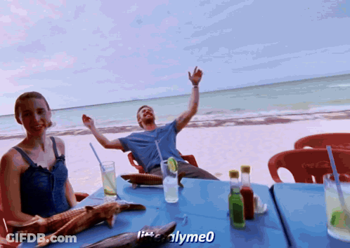 Man And Woman Sitting At Beach Table With Coca Cola GIF