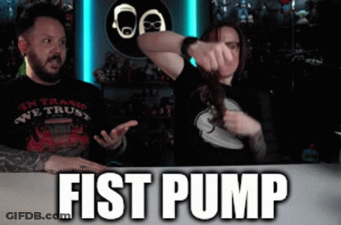 Man And Woman Sitting At Fist Pump Table GIF