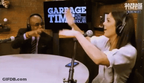 Man And Woman Sitting At Garbage Time Sign GIF
