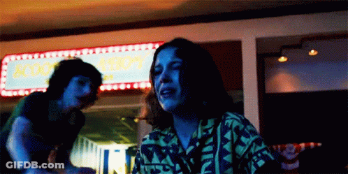 Man And Woman Sitting At Mall Sign GIF