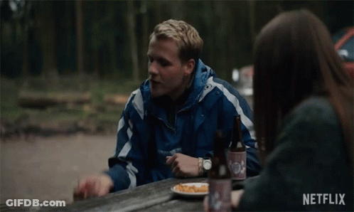 Man And Woman Sitting At Picnic Table With Plate Of Food GIF