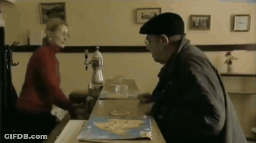 Man And Woman Sitting At Restaurant Table GIF