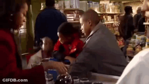 Man And Woman Sitting At Store Counter GIF