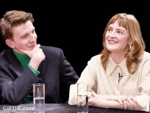 Man And Woman Sitting At Table GIF