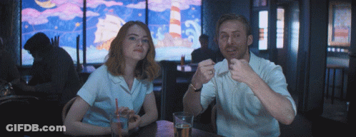 Man And Woman Sitting At Table Eating And Drinking GIF