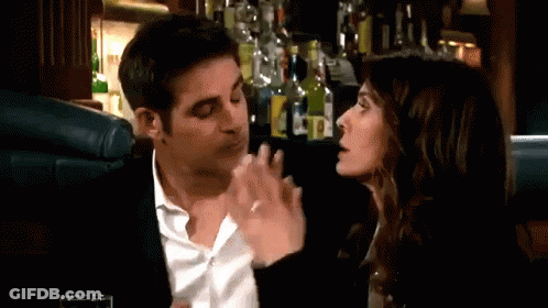Man And Woman Sitting At Table In Bar GIF