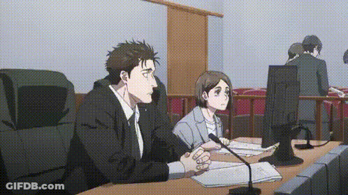 Man And Woman Sitting At Table In Courtroom GIF