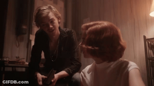 Man And Woman Sitting At Table Looking At Each Other GIF