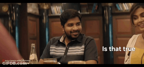 Man And Woman Sitting At Table GIF