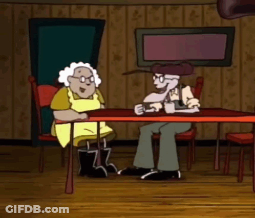 Man And Woman Sitting At Table GIF