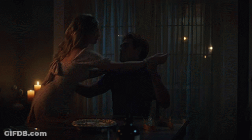 Man And Woman Sitting At Table With Candles GIF