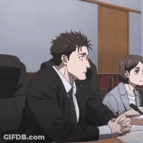 Man And Woman Sitting At Table With Hands Folded GIF